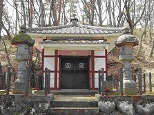 対になった石灯篭の先に瓦屋根の堀直虎御霊屋が建っている写真