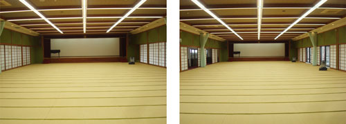 臥竜山公会堂大広間の写真。畳の部屋、正面にステージ、部屋の両側は障子で、障子を開けば臥竜公園が一望できる。