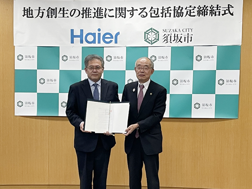 ハイアールジャパンセールス株式会社の乾副社長とともに、協定書を持つ三木市長の写真