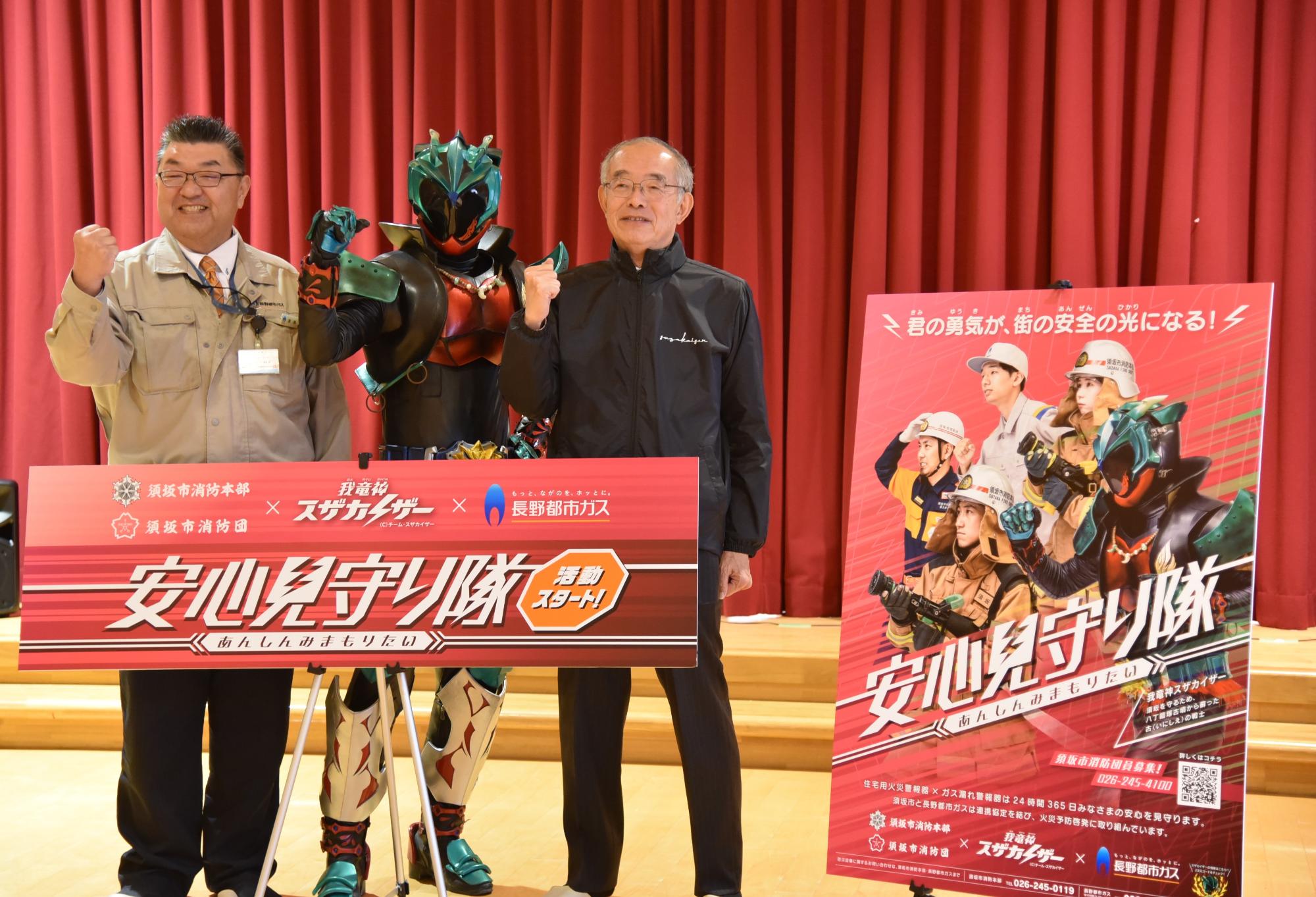 須坂市長と長野都市ガス取締役北信支店長とスザカイザーがガッツポーズしている写真